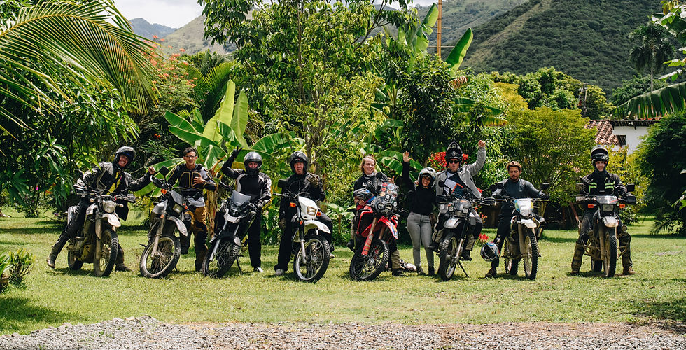 Nine motoryclists waving at camera
