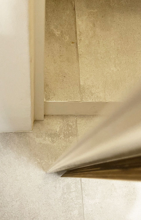 Stainless steel appliance corner on beige tile floor