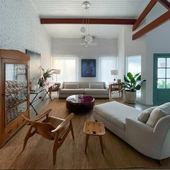 Modern living room with wooden beams, comfy seating, and statement art