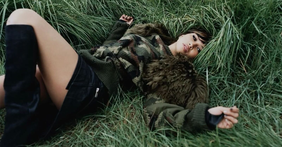 Beabadoobee, lying on grass. (PHOTO CREDIT: BILLBOARD)