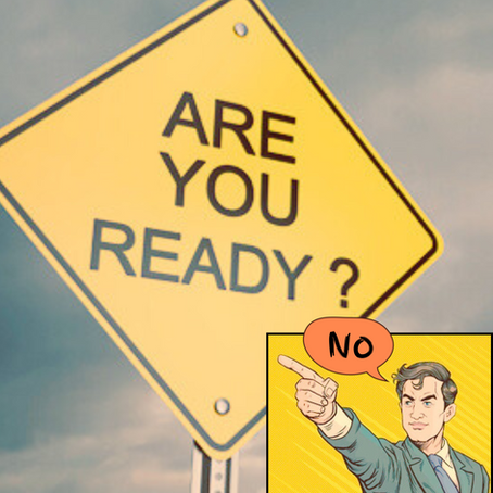 An "are you ready" sign with a cartoon man saying "no".