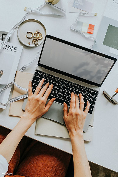 Download premium image of Aerial view of woman using a computer laptop on a table workplac