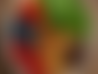 Plate with strawberries, blueberries, raspberries, almonds, walnuts, chocolate, spinach. Wood background, vibrant colors, healthy vibe.