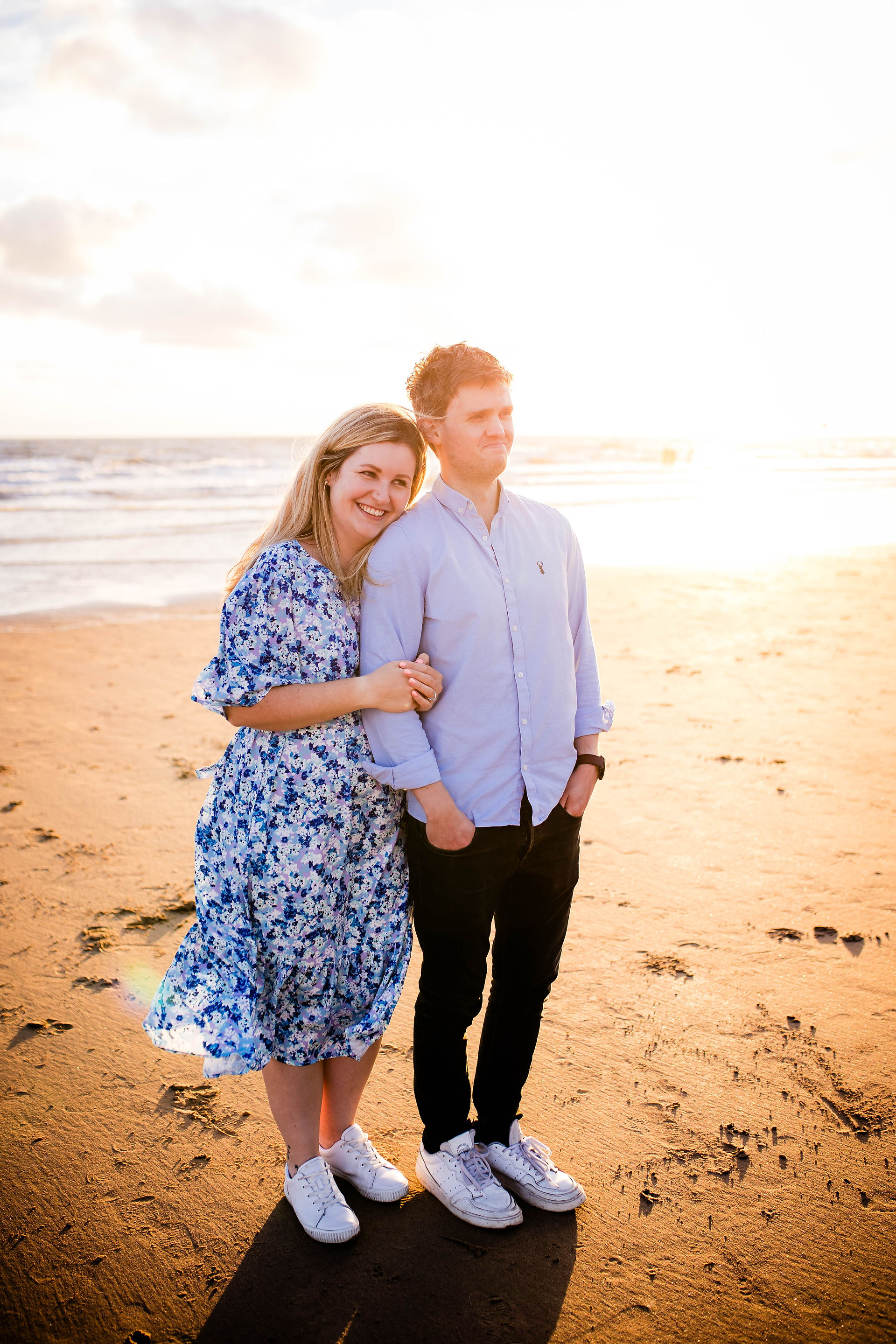 A couple on the beach during their golden hour engagement session