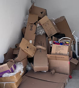 Pile of junk and cardboard boxes in a garage before mighty mouse junk removal clean it out in Vanier