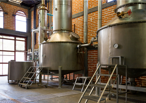An image of a storage tank farm at a biogas plant, featuring an array of tanks equipped with breather valves and other tank protection equipment. The breather valves, essential for maintaining pressure balance, are visible on the tops of the tanks. This photo illustrates the utilisation of advanced equipment in food and beverage plant, showcasing the commitment to safety and efficient operation through tank protection measures.