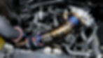 Close-up view of a polished BMW charge pipe installed in an engine bay