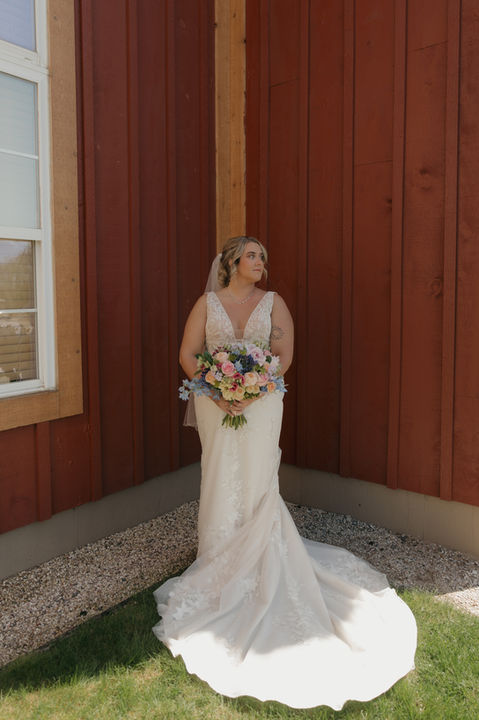 Bride with large bridal bouquet at Caberfae Peaks