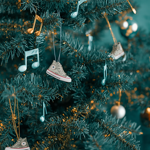 A Christmas tree in teal and gold colors, decorated with small sneakers and musical notes