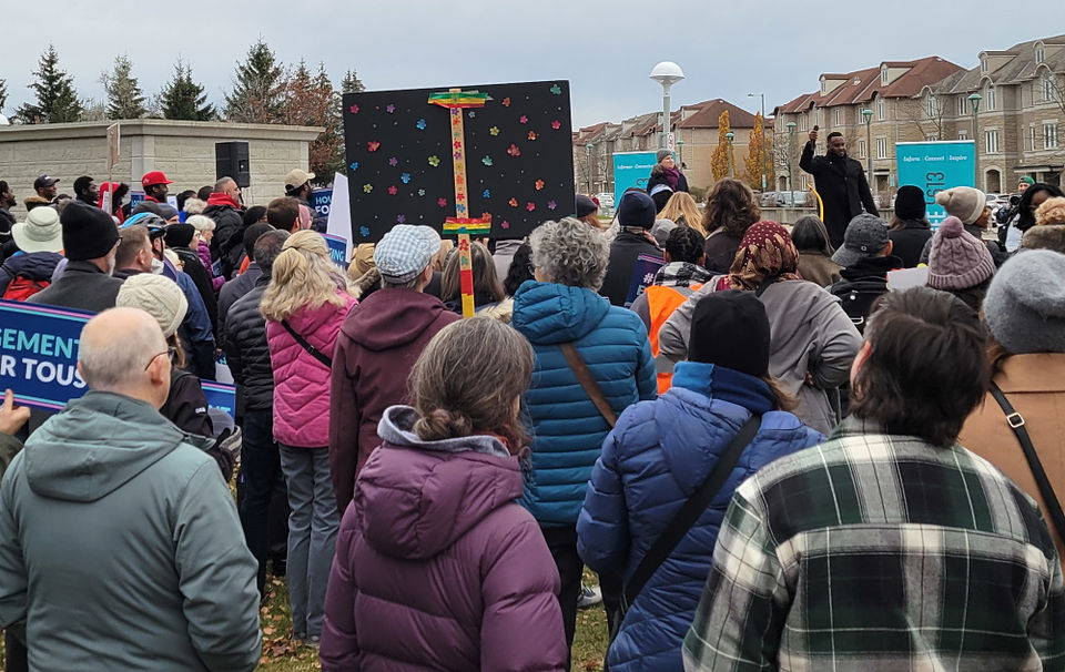 Large group of people watching speakers at a rally