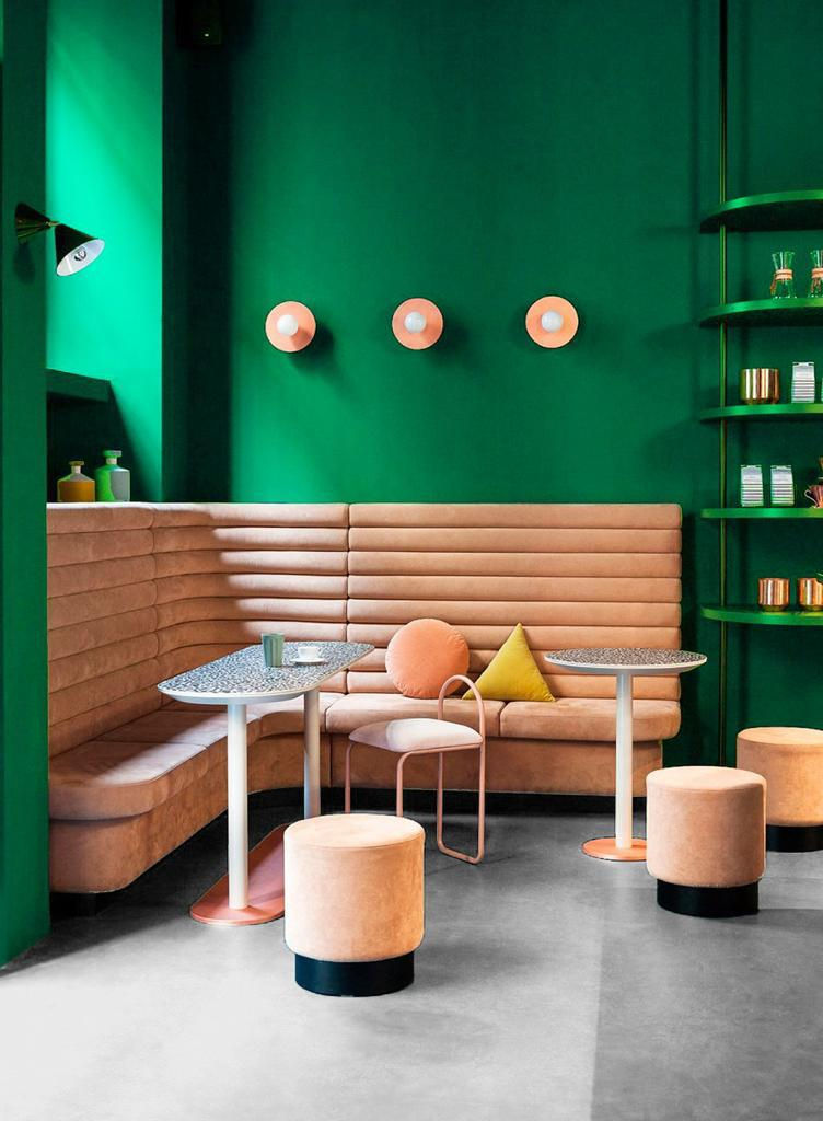 Green-walled cafe interior with booth seating