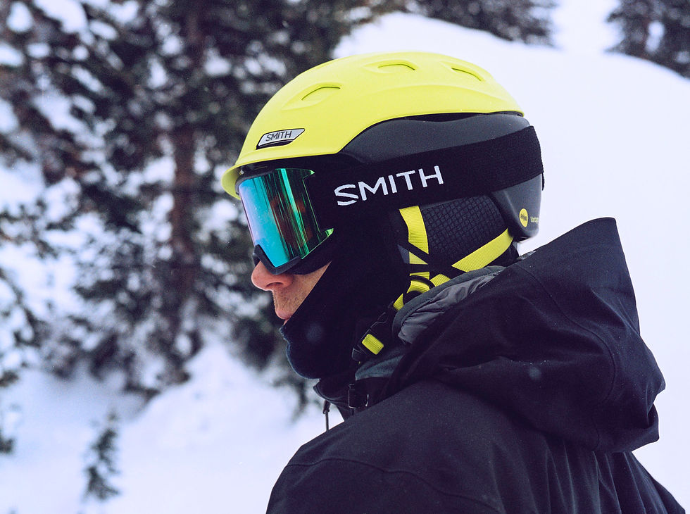 Lifestyle outdoor product image of Smith goggles and helmet on a man. With a snowy background.