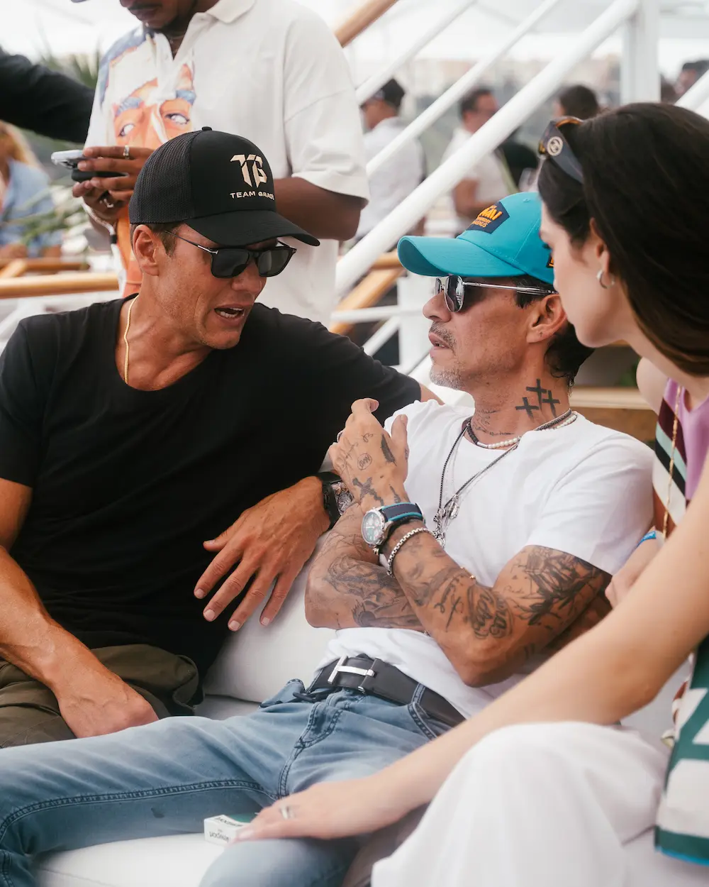 Marc Anthony shares a conversation with other E1 Series team owner, Tom Brady, during the Monaco Grand Prix, all wearing relaxed Team Miami apparel