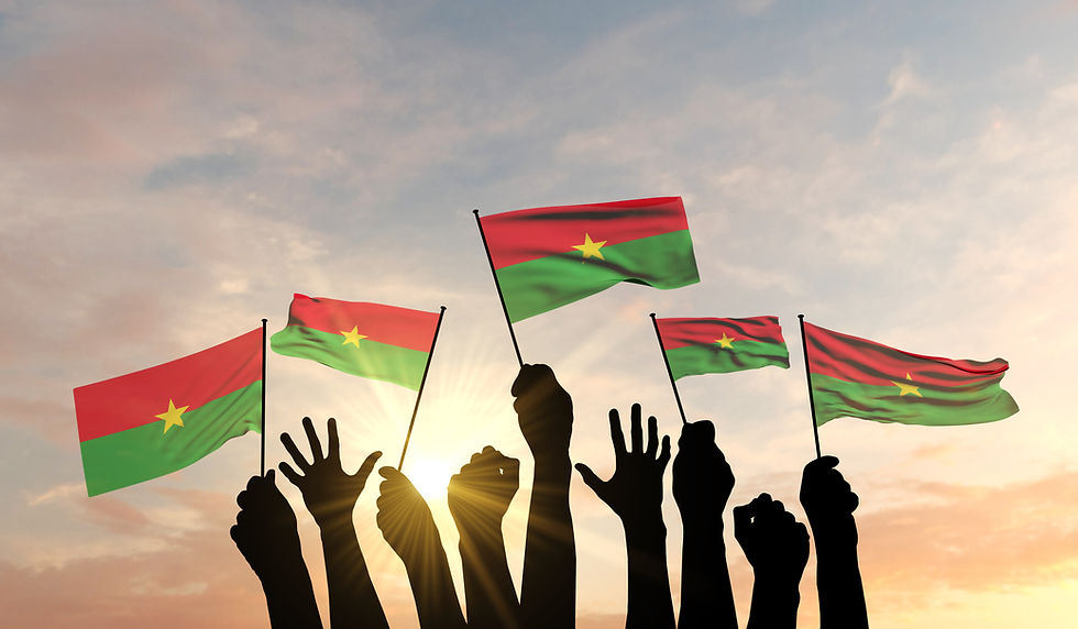 People raising Burkina Faso flags in support of unity, peace, and national identity.