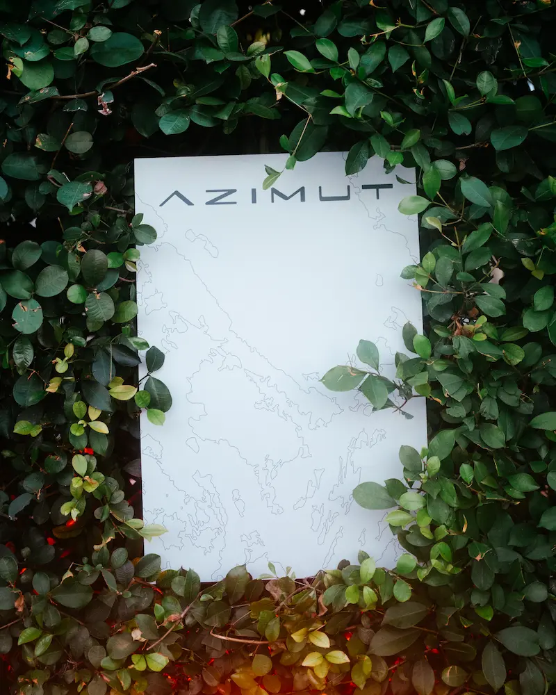 Azimut Yachts signage surrounded by lush foliage, marking the exclusive waterfront venue during E1 Team Miami’s Monaco activation.