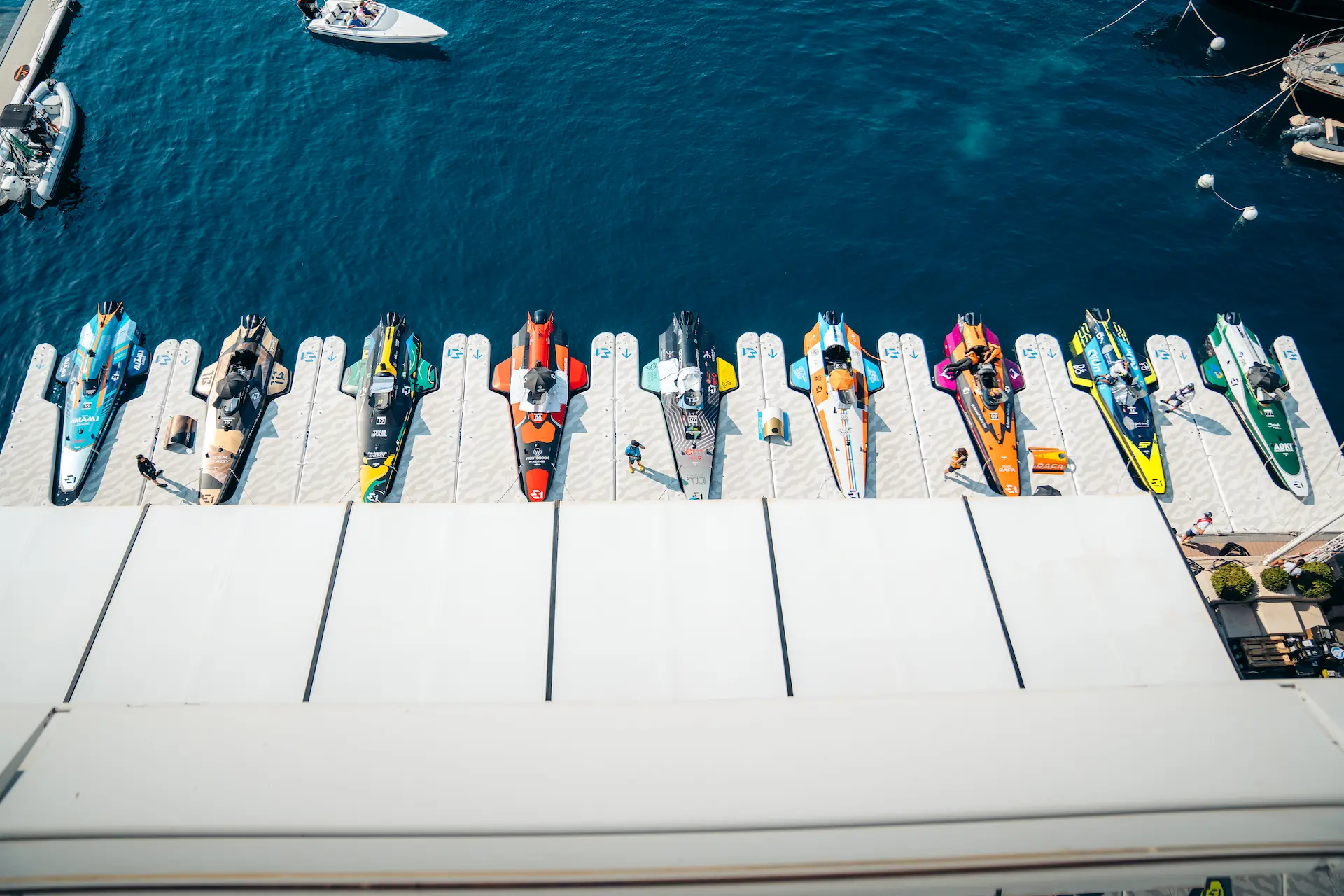 Top-down view of E1 Series Racebirds from various teams—including E1 Team Miami—lined up at the marina before the start of race day in Monaco, highlighting the sport’s vibrant energy and technical design.