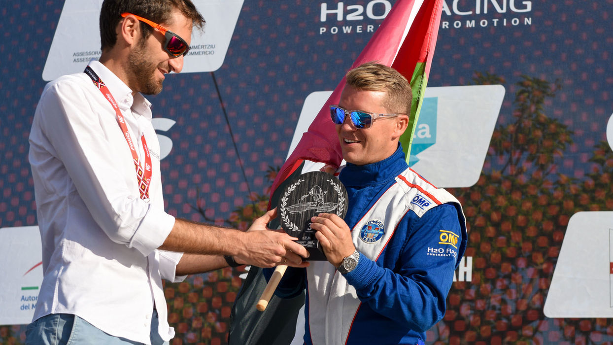 Erik Stark accepting an award during a post-race ceremony with a race fan.