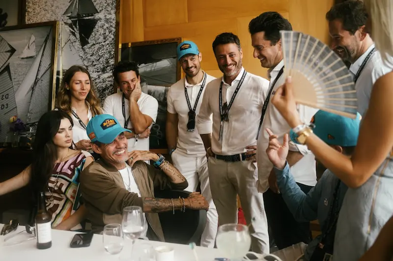 Team Miami guests and partners share a lighthearted moment in a hospitality suite, reflecting the brand’s spirit of camaraderie, community, and elevated experiences off the water.