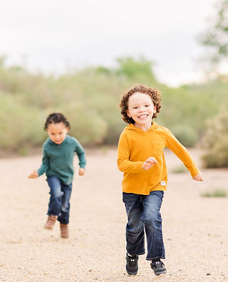 Two young boys running