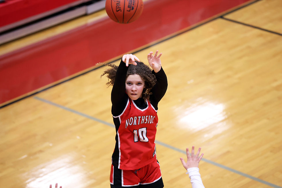 Middle school girl in Northside jersey shooting a basketball