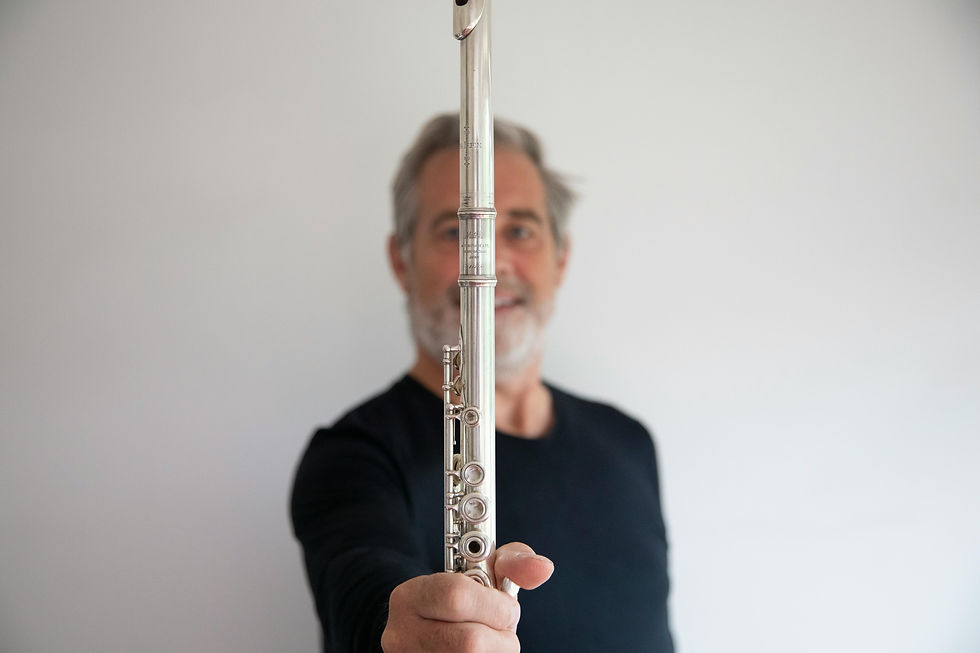 Man holding a flute at camera
