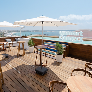 Branded event environment and experiential marketing for Walmart Connect at a leading industry conference. Furnished terrace with large 3D logo in rooftop pool