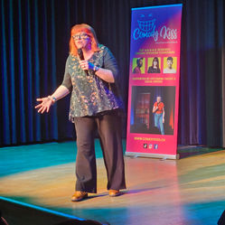 Angela Barnes on stage at a Comedy Kiss English comedy night.