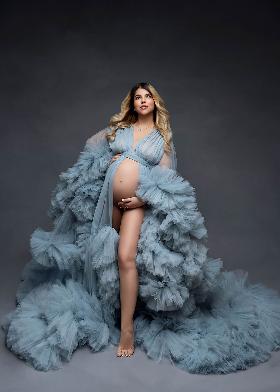 Expecting mother in voluminous blue tulle robe maternity gown at Imagine That Photography studio Dix Hills Long Island
