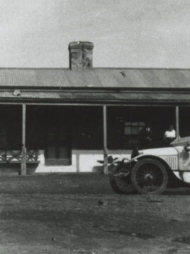 An early automobile outside the Blinman Hotel. Imagine the (lack of) suspension!