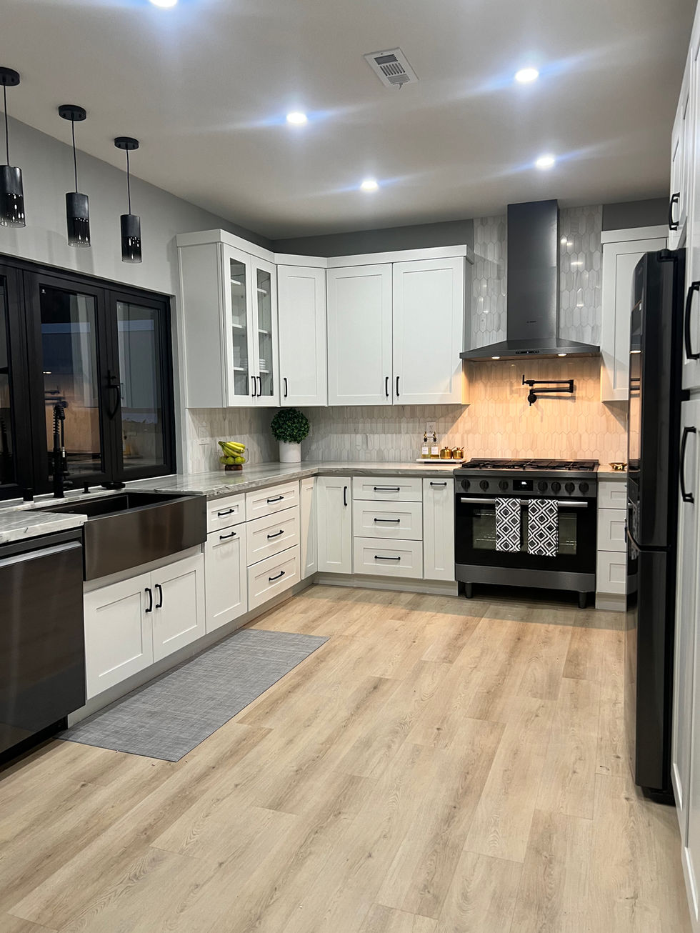 a kitchen with white cabinets and black appliances