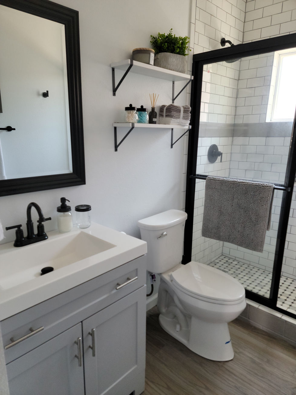 a bathroom with a toilet a sink and a mirror