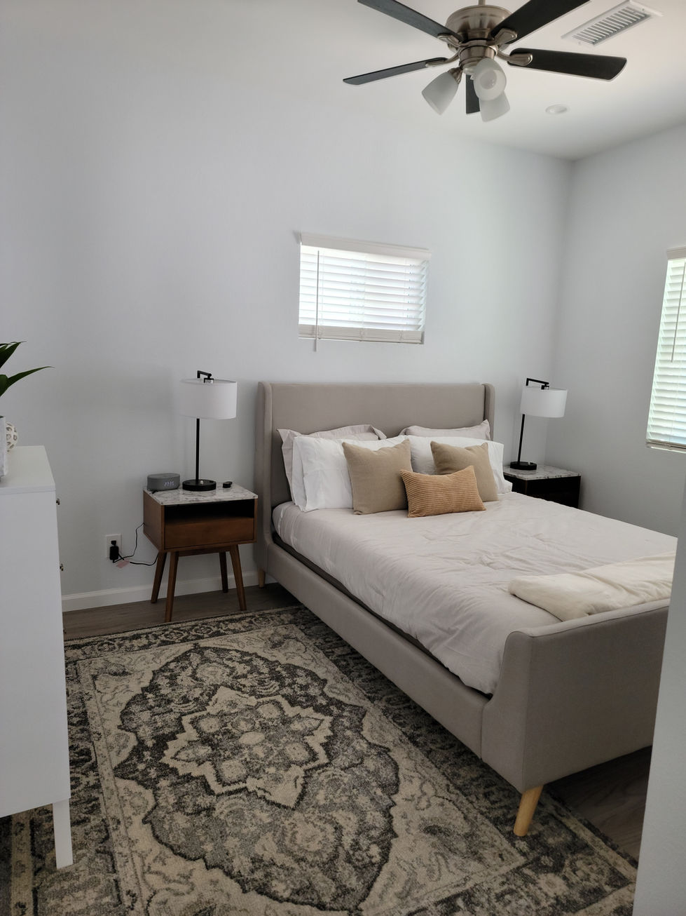 a bedroom with a bed and two nightstands