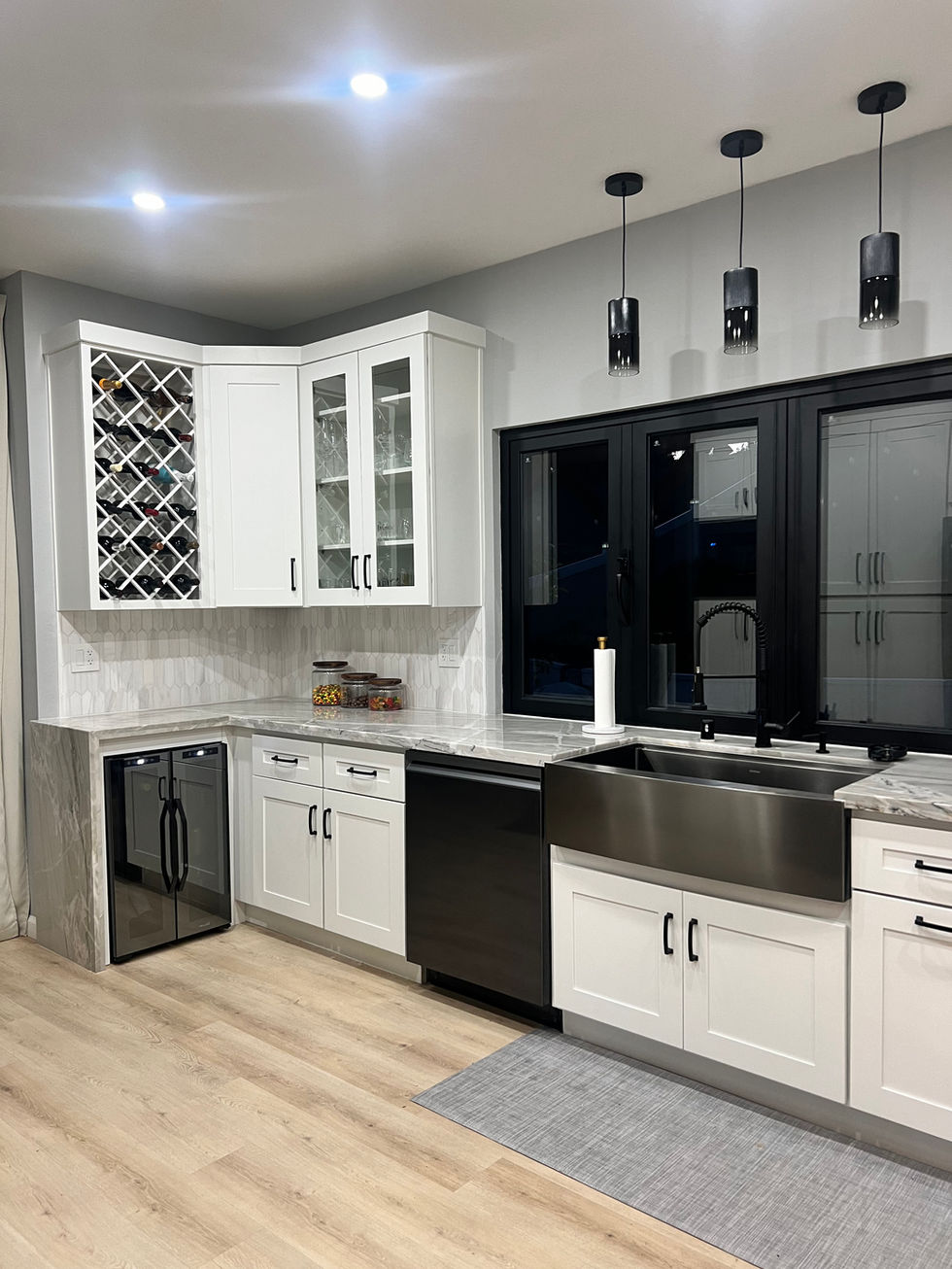 a kitchen with white cabinets and a stainless steel sink