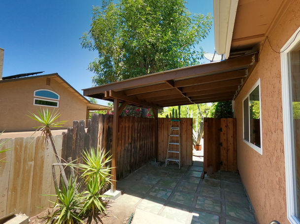 Custom wood patio cover installation providing outdoor shade for a residential backyard in San Diego.