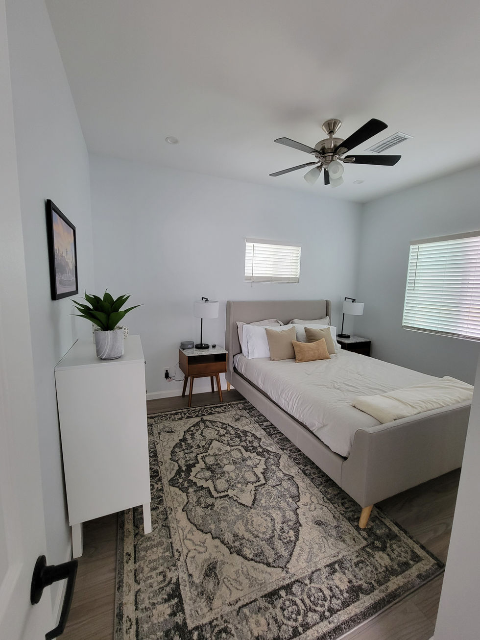 a bedroom with a bed and a ceiling fan