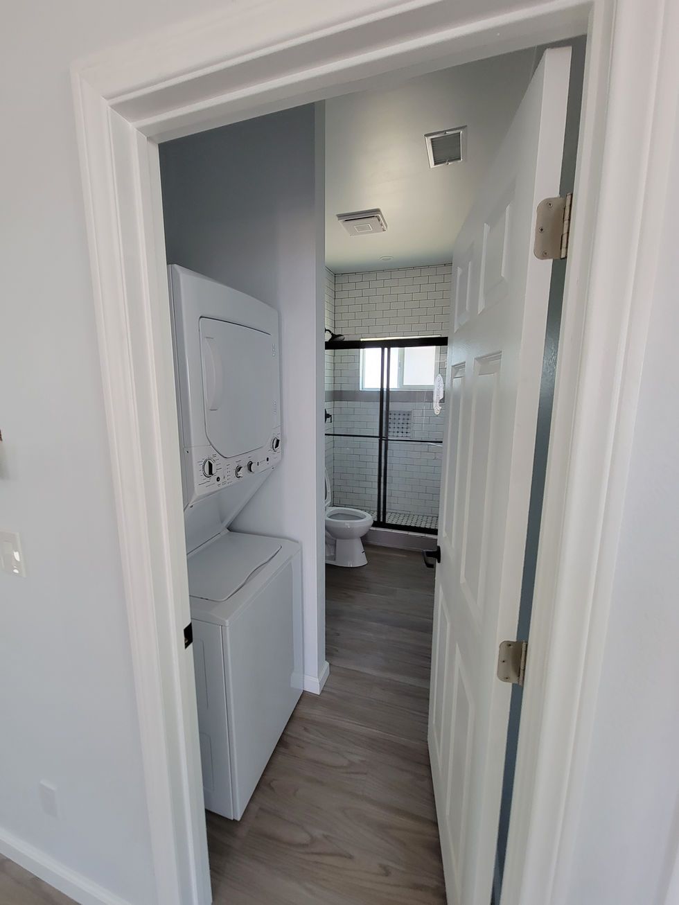 a washer and dryer in a bathroom next to a toilet