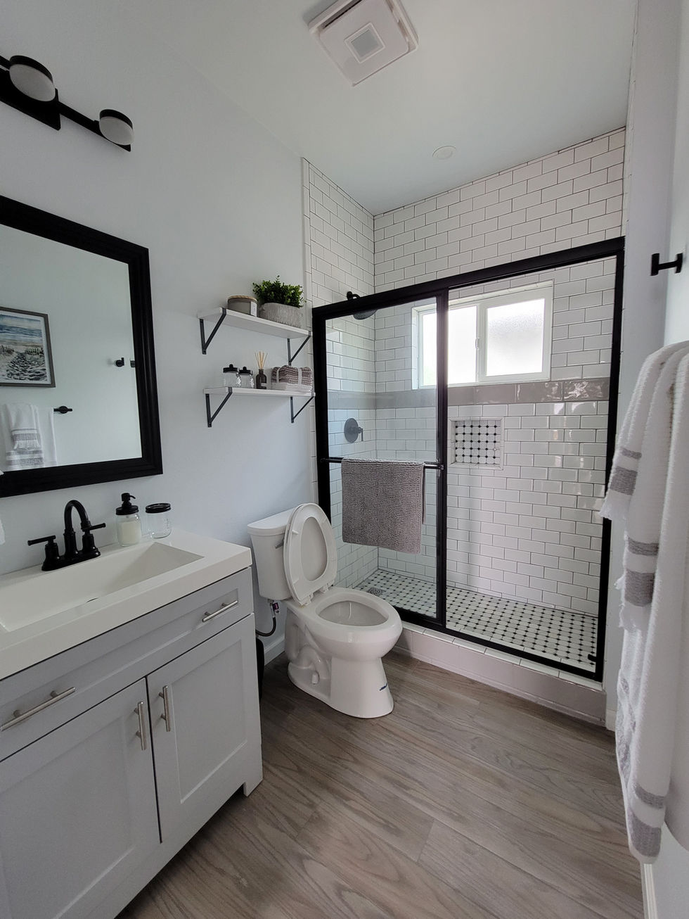a bathroom with a toilet a sink and a shower