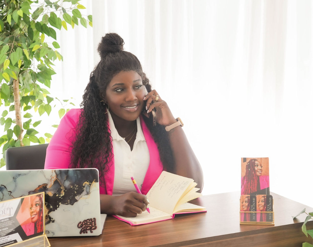 Simone on the phone with a client sitting at a desk