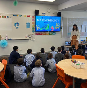Caitlin Nicholls presenting to students at a local school as part of educational outreach