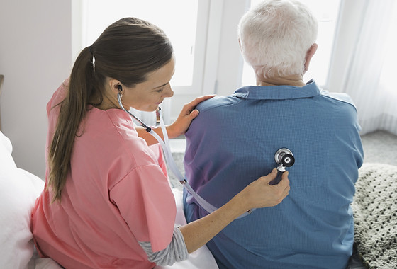 Home Nurse Examining Patient