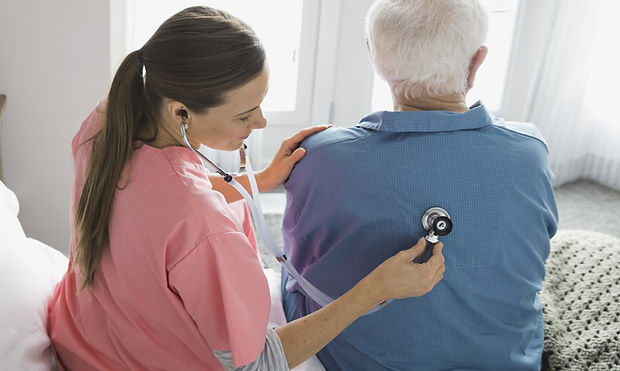 Home Nurse Examining Patient