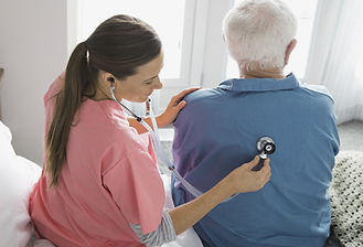 Home Nurse Examining Patient