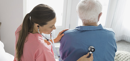 Home Nurse Examining Patient