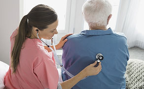 Home Nurse Examining Patient