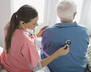 Nurse checking patient's back
