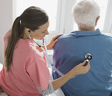 Home Nurse Examining Patient