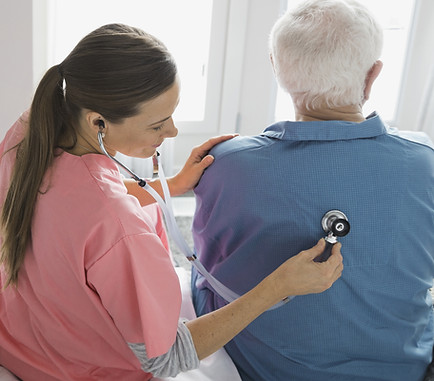 Home Nurse Examining Patient