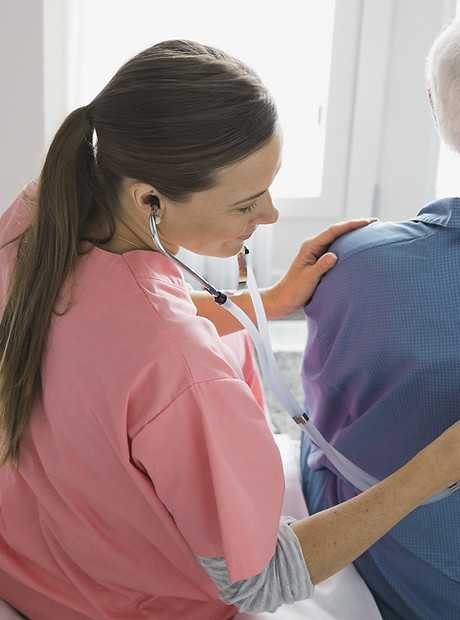 Home Nurse Examining Patient