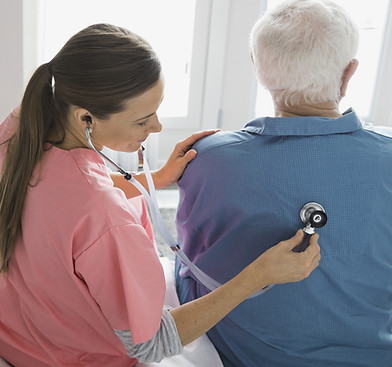 Home Nurse Examining Patient