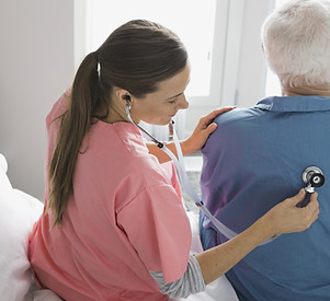 Woman Physician Examining Patient at Home